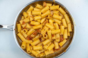 Adding the pasta to the sauce