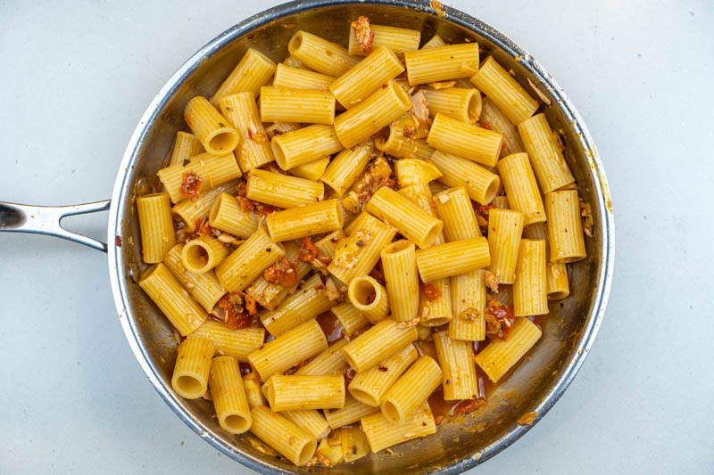 Adding the pasta to the sauce
