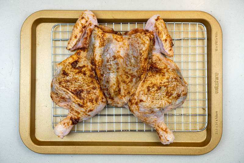 Applying the spice rub to the chicken