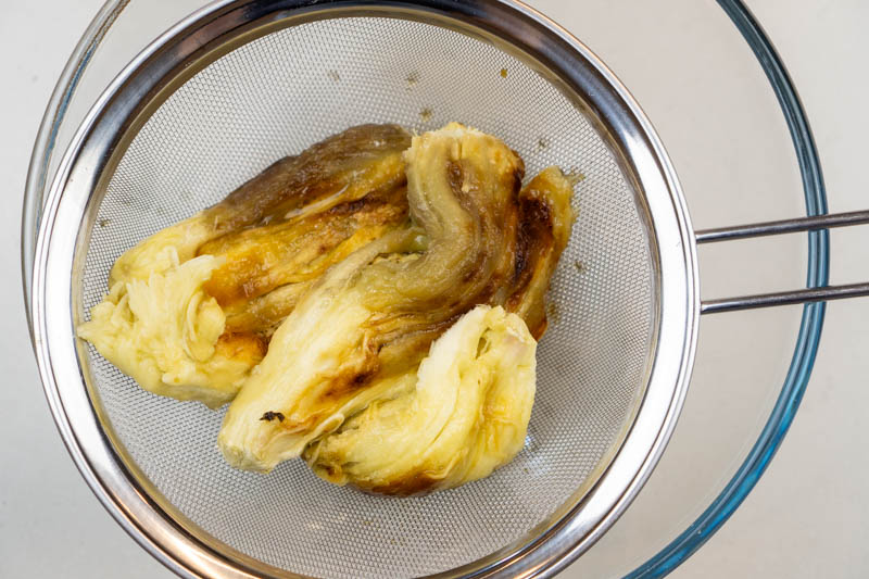 Draining the moisture from the eggplants