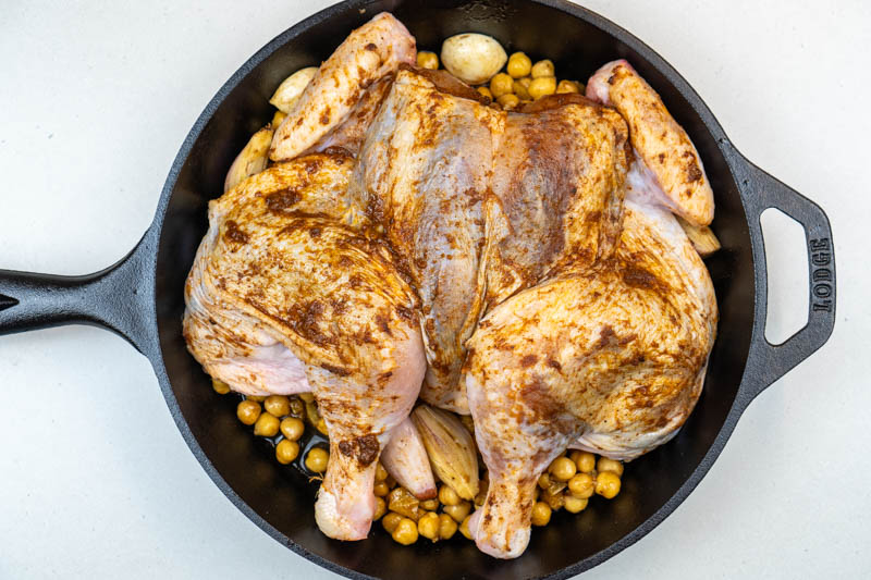 Adding the chicken to the cast iron