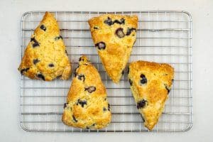 Removing the scones from the oven
