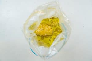 Adding the lemon zest & olive oil to a bag