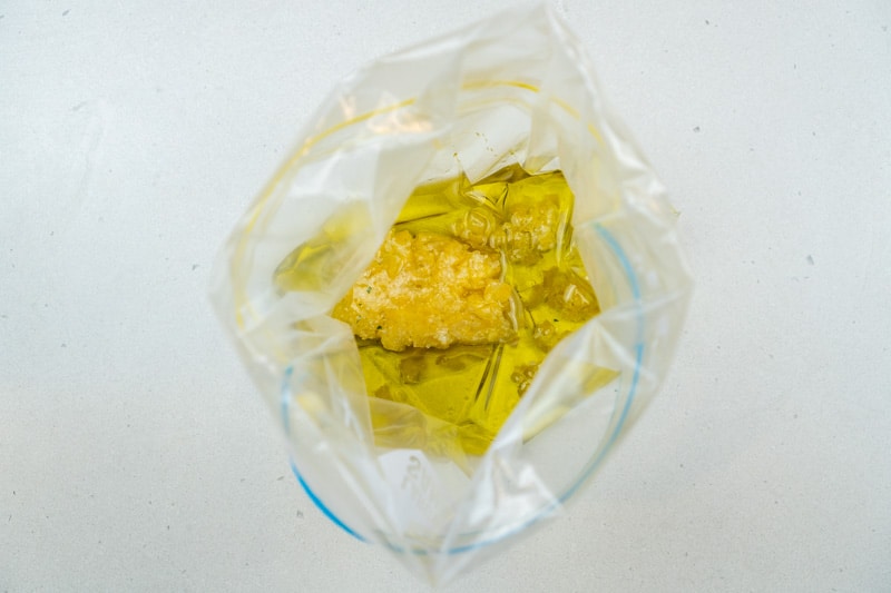 Adding the lemon zest & olive oil to a bag