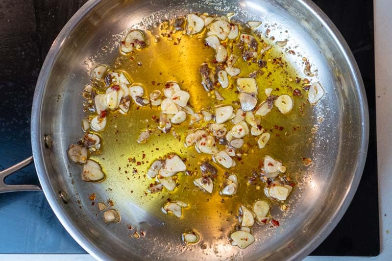 Cooking the garlic, anchovies and chili flakes