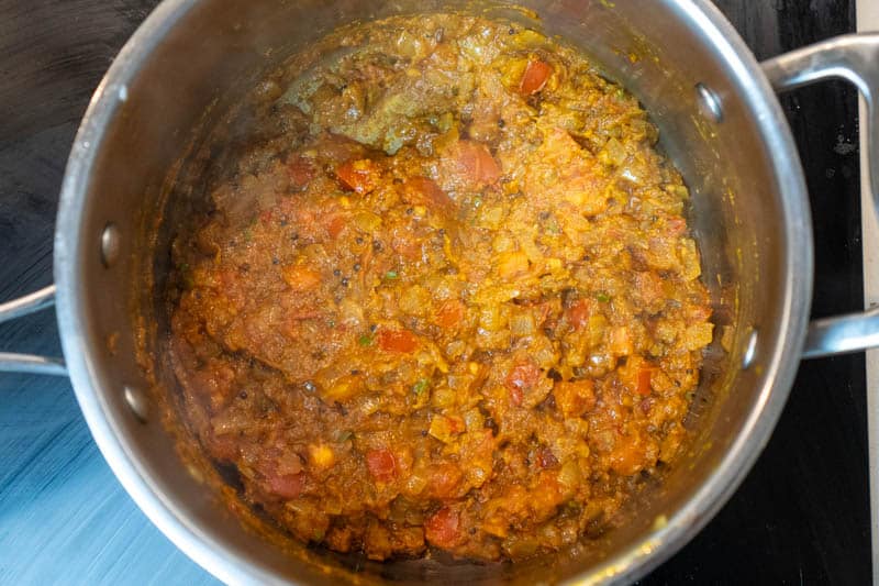 Stirring in the tomatoes