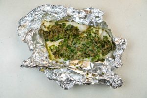 Removing the cod from the oven