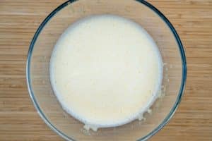 Adding the eggs to the milk