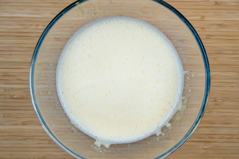 Adding the eggs to the milk
