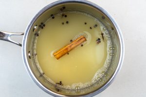 Adding the spices to the apple juice