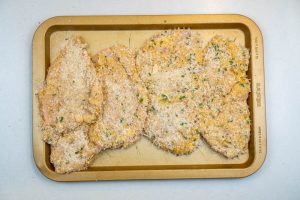 Coating the chicken in the breadcrumbs