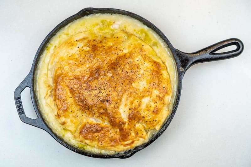 Removing the pot pie from the oven