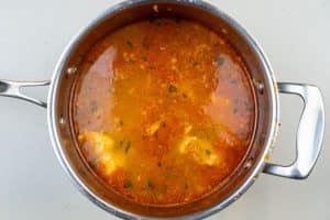 Adding the seafood to the stew