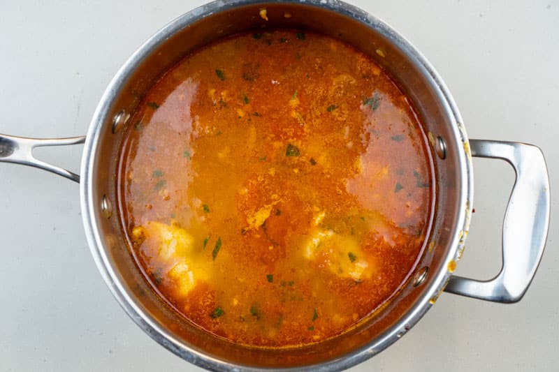 Adding the seafood to the stew
