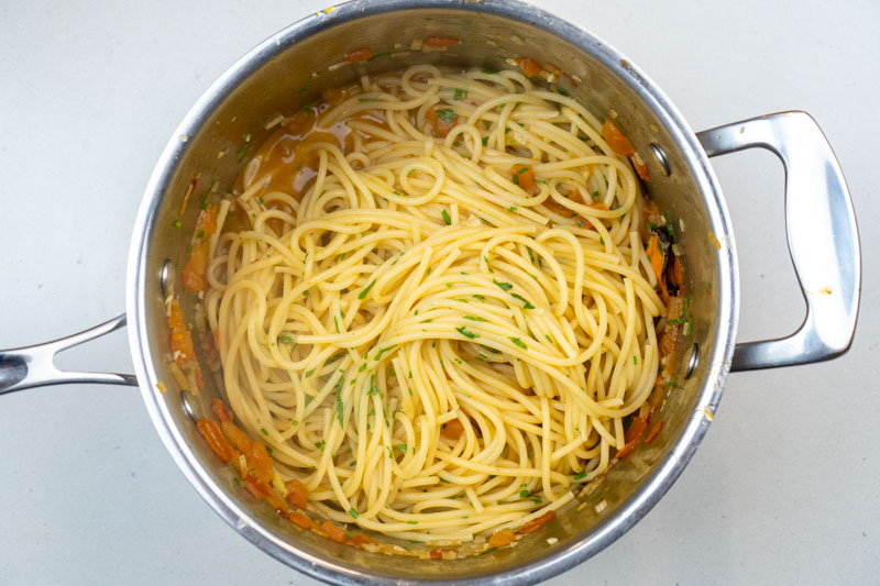 Adding the pasta to the sauce