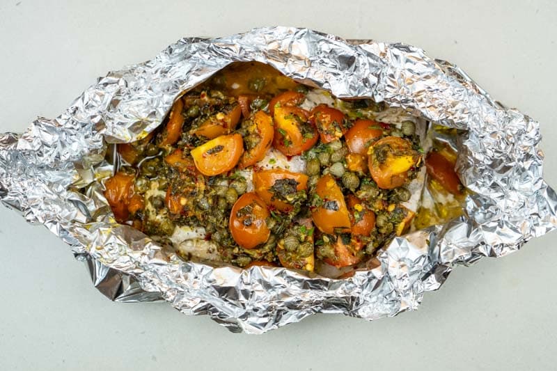 Removing the fish from the oven