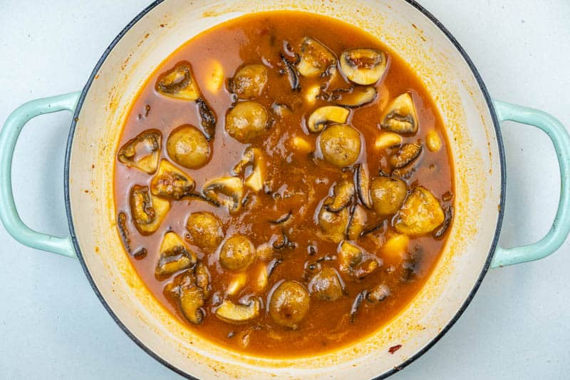Adding the garlic, tomato paste and stock