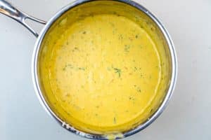 Whisking in the sour cream, cilantro & hot sauce