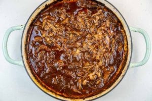 Shredded lamb added back to the sauce